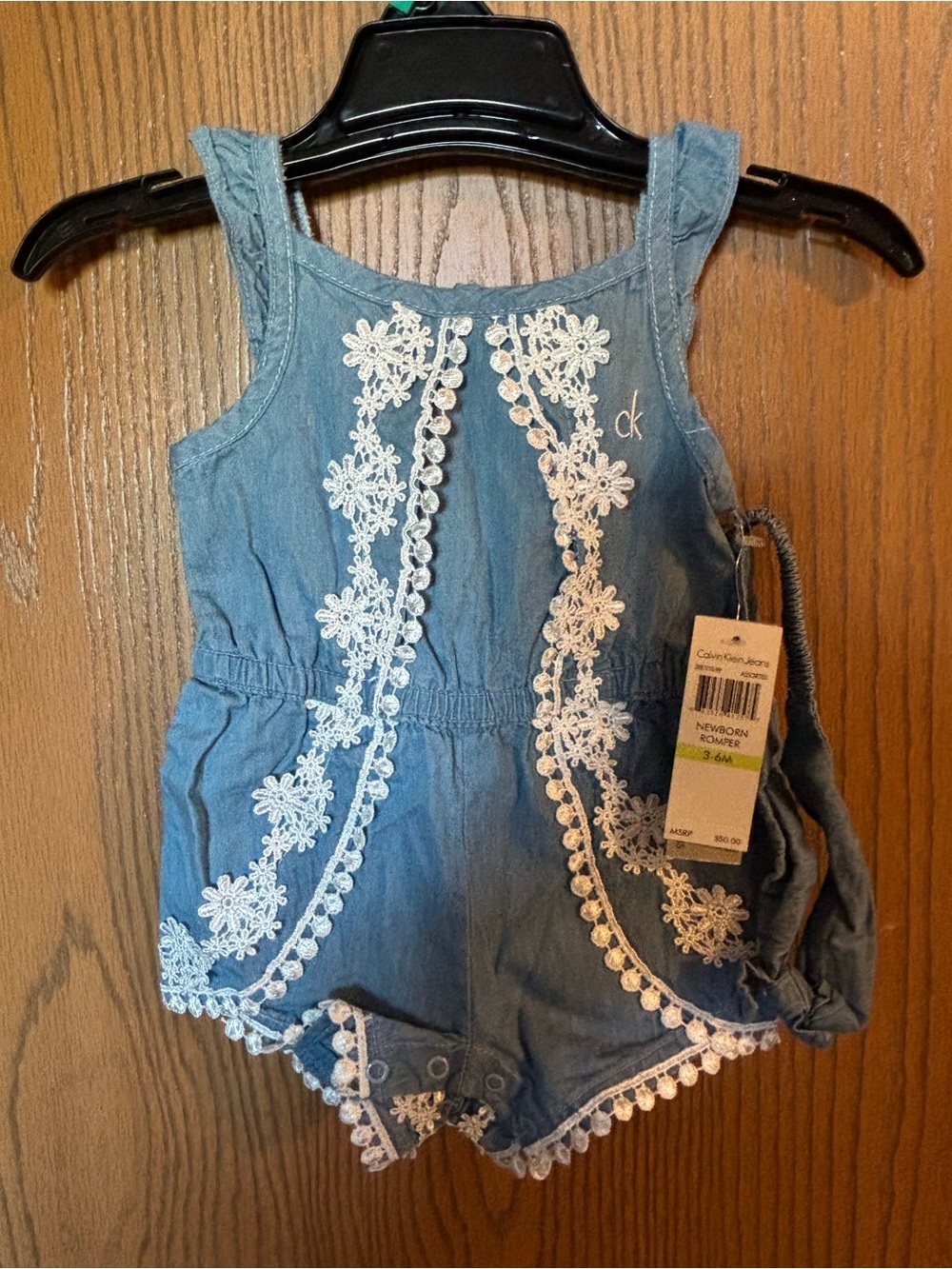 Calvin Klein Jeans Light Blue Denim Baby Romper with White Lace Floral Detail